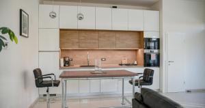 a kitchen with a table and chairs in a room at Open Space in Varaždin
