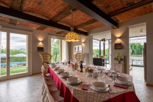 a long table in a room with a red table cloth at Casa San Grato in Monteu Roero