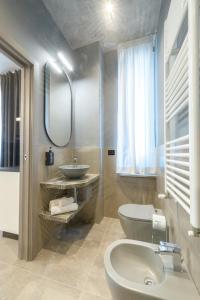 a bathroom with a sink and a toilet at Room Don Alfonso Luxury in Parma