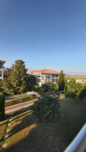 a view of a yard with trees and a building at 5 YILDIZLI OTEL KONFORU in Antalya