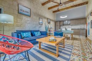a living room with a blue couch and a table at Le Petit Voyage - CHILL OUT in Cospicua