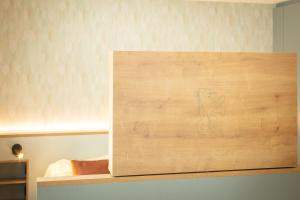 a wooden box with a drawing on it on a shelf at Hotel zum Löwen in Weißenhorn