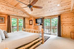 a log cabin bedroom with a bed and a balcony at Lakeview Lookout in Wisconsin Dells