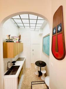 a small kitchen with a sink and a table at 2 pièces à Bastille in Paris