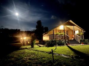 a house lit up at night with the moon at Terre del Piano in Corinaldo