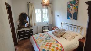 a bedroom with a bed and a mirror and a dresser at El huerto de la Reina in Becerril de la Sierra