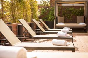 a row of lounge chairs on a patio at U232 Hotel in Barcelona