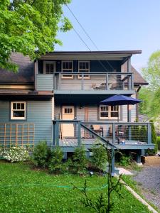 a large house with a porch and a balcony at Hÿgge House in Margaretville