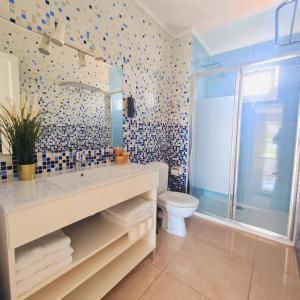 a bathroom with a sink and a toilet at Tabbu ibiza apartments in Playa d'en Bossa