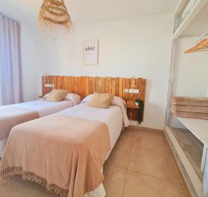 a bedroom with two beds in a room at Tabbu ibiza apartments in Playa d'en Bossa