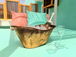 a champagne bottle in a bucket on a table with a glass at Tabbu ibiza apartments in Playa d'en Bossa