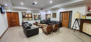 a living room with two couches and a table at Hotel y Cabañas Las Mellizas - Caja Los Andes in Los Ángeles