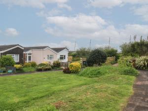 a view of a house with a yard at Sunny Breeze in Kingsbridge