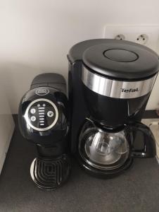 a coffee pot sitting on top of a counter at L'Altéia - L'appartement les pieds dans l'eau avec place de parking privé et accès direct à la plage in Berck-sur-Mer