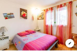 a bedroom with a bed with pink sheets and a window at 2 CHAMBRES B&B PRÈS DE L'AÉROPORT ET DU MEETT in Blagnac +40 photos