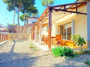 a house with a patio and a table and chairs at House with pool near Park Guell in Barcelona