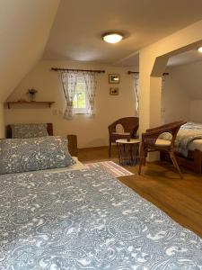 a bedroom with two beds and a table and chairs at Pension Soutěsky in Hřensko