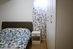 a bedroom with a bed next to a door at Apartment Neiv in Tivat