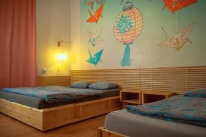 a bedroom with two beds and a wall with stars at Hostel Elf in Prague