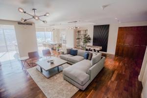 a living room with a couch and a table at Nasma Luxury Stays - Limestone House in Dubai