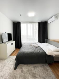 a bedroom with a large bed and a large window at CUBE House in Kyiv
