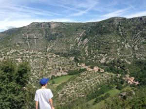 Un ragazzo in piedi sulla cima di una montagna che guarda una valle di Octon, Villa Plain-pied, Piscine a Octon
