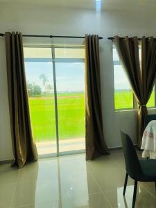 a room with a large window with a view at Aisyy homestay in Kampong Sungai Baru