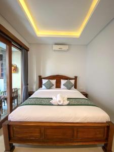 Postel nebo postele na pokoji v ubytování Kope House Ubud