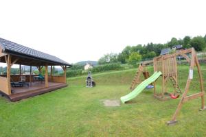 a playground with a slide and a gazebo at Baza w Bieszczady in Solina