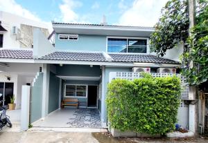 a blue and white house with a fence at Nimman home 4 bedroom near One Nimman in Chiang Mai