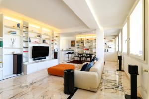 a living room with a couch and a tv at Peaceful Penthouse with Garage - NDP Rent in Rome