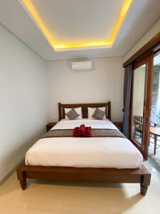 Postel nebo postele na pokoji v ubytování Kope House Ubud