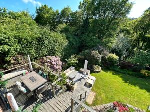 an overhead view of a garden with a wooden deck at Stunning Surrey Hills Country House set in half an acre in Hindhead