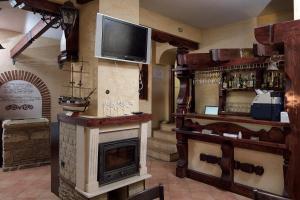 a room with a fireplace and a tv on the wall at House Diona in Sozopol
