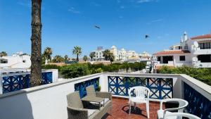 a balcony with two chairs and a table and chairs at Jardim da Oura by Check-in Portugal in Albufeira