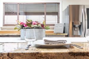 a table with a plate and glasses and a window at Telluride Mainstreet 2 Bedroom Condo in Telluride