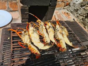 a group of lobsters cooking on a grill at Wagawimbi Villa 560 m2, Breathtaking View of the Indian Ocean, Kenya in Shimoni