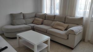 a living room with a couch and a table at Casa Rubio in Chiclana de la Frontera