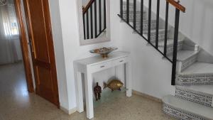 eine Treppe mit einem weißen Tisch und einer Schüssel darauf in der Unterkunft Casa Rubio in Chiclana de la Frontera