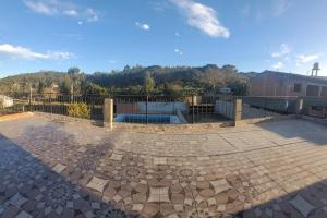 a patio with a pool and a fence at EL ESTABLO - Casa de Campo Vacacional con pileta privada - Jujuy in San Salvador de Jujuy