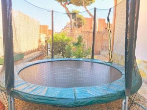 an empty trampoline in a batting cage at House with pool near Park Guell in Barcelona +19 photos