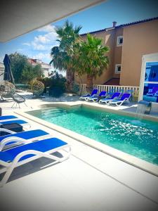 a swimming pool with lounge chairs and a swimming pool at Villa Antonio in Novalja