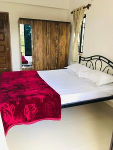 Mahalaxmi Homestay Mapusa tesisinde bir odada yatak veya yataklar