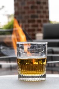 a glass of whiskey sitting on a table at Marriott Boston Quincy in Quincy