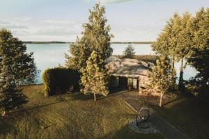 an aerial view of a house with trees and water at Your Private Retreat Island in Priedkalne