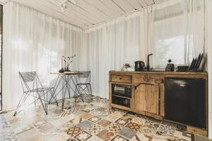 a living room with a tv and a table and chairs at Your Private Retreat Island in Priedkalne