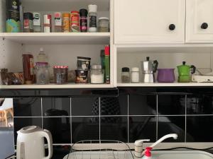 a kitchen with black and white tiles on the wall at Eden Garden near Knossos in Skalánion +48 photos