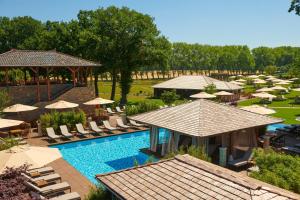 an aerial view of a resort pool with umbrellas and chairs at Vabali Spa Hamburg Hotel in Glinde