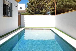 a swimming pool in the backyard of a house at Casa Paqui 3 in Roche