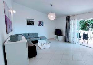 a living room with a couch and a tv at Villa Ana Sevid in Sevid